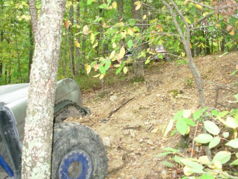 1983 Ford Bronco - Two off-road vehicles navigate a wooded trail during an outing.