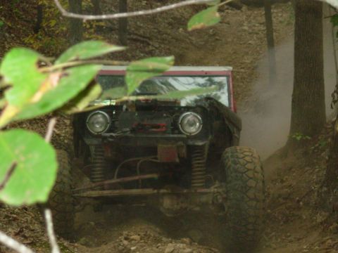 1983 Ford Bronco - This classic Ford Bronco navigates a challenging off-road trail, its build evident.