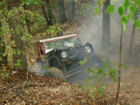 1983 Ford Bronco - This 1983 Ford Bronco navigates a steep, wooded trail, kicking up dust and smoke.