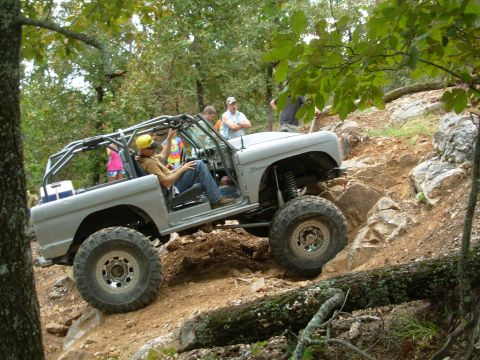 1983 Ford Bronco - This modified off-road vehicle navigates a challenging rocky incline, its capabilities.