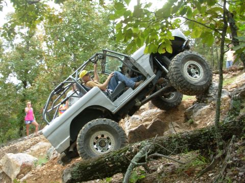 1983 Ford Bronco - Modified 1983 Ford Bronco navigates a steep, rocky trail during an off-road event.
