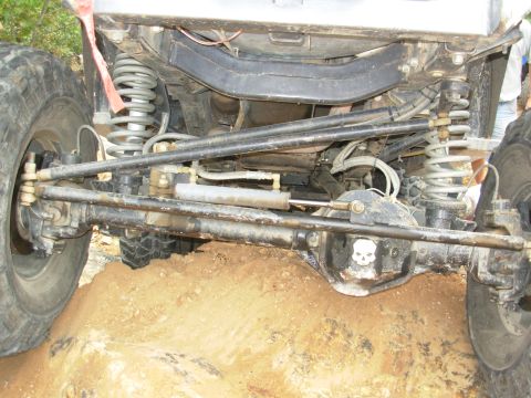 1983 Ford Bronco - Close-up view of the heavy-duty suspension and steering components of an off-road vehicle.