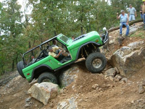 1983 Ford Bronco - This modified Ford Bronco navigates a steep, rocky trail, its off-road capabilities.