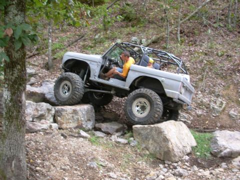 1983 Ford Bronco - This modified 1983 Ford Bronco navigates a challenging rocky terrain during an off-road excursion.