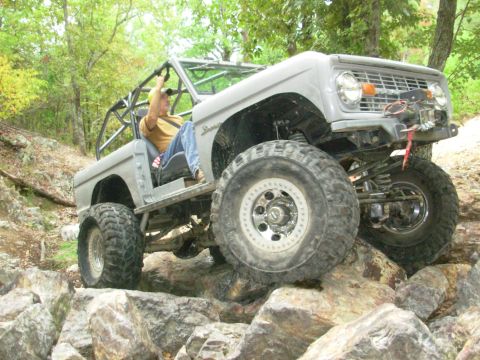 1983 Ford Bronco - Modified Ford Bronco off-roading over large rocks.