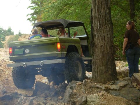 1983 Ford Bronco - Ford Bronco navigating a rocky trail with passengers.