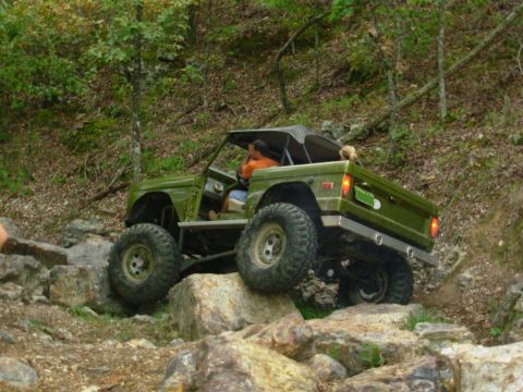 1983 Ford Bronco - This modified SUV navigates a rocky trail with its top down.