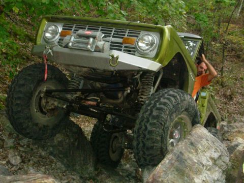 1983 Ford Bronco - Modified 1978 Ford Bronco navigates a rocky trail with a driver visible inside.