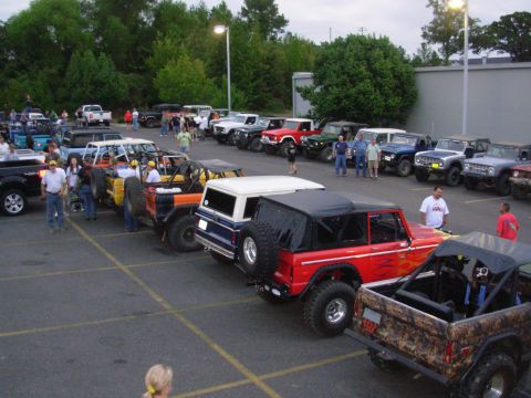 1983 Ford Bronco - A gathering of Ford Broncos, many modified, parked in an outdoor lot.