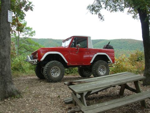 1983 Ford Bronco - This lifted Ford Bronco is parked at a scenic overlook with a picnic table in the foreground.