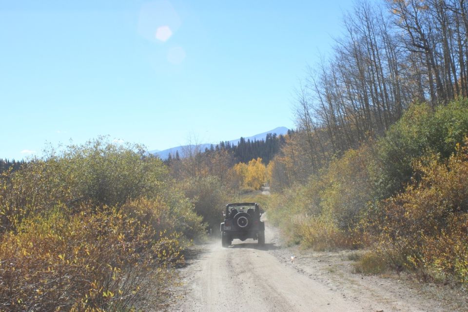 Jeep Wrangler on a dirt road in autumn