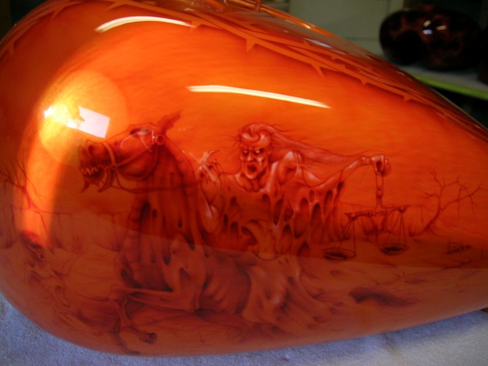 motorcycle gas tank with airbrushed art of a demon on a horse holding scales