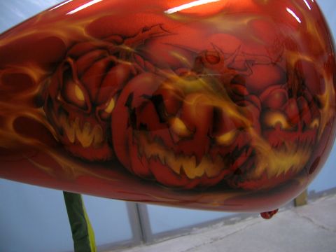 2010 Harley-Davidson Electra Glide - Motorcycle fuel tank features a custom paint job with airbrushed jack-o'-lanterns and flames in red and orange.