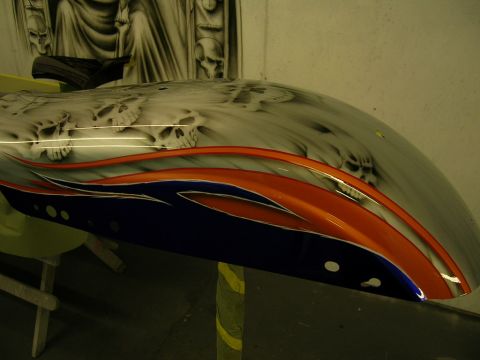 2010 Harley-Davidson Electra Glide - Custom painted motorcycle fender features a detailed airbrushed skull design with vibrant flame graphics in orange and blue.
