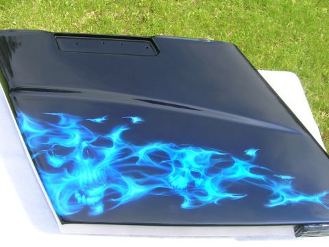 2010 Harley-Davidson Electra Glide - A black motorcycle fairing features custom airbrushing of blue flames and skulls.