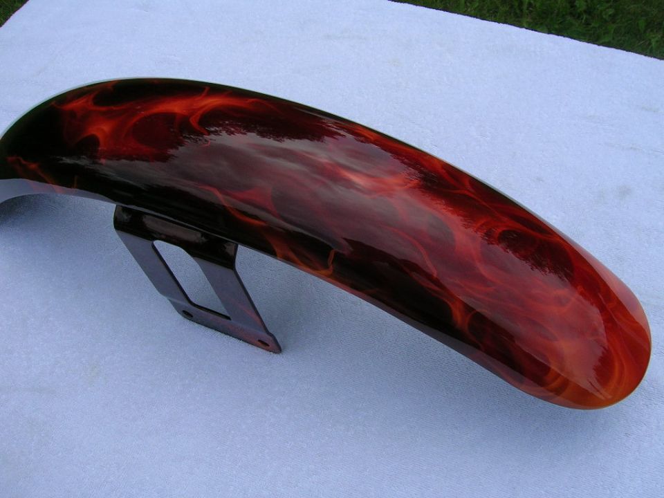 Motorcycle fender with custom flame paint job in red and black