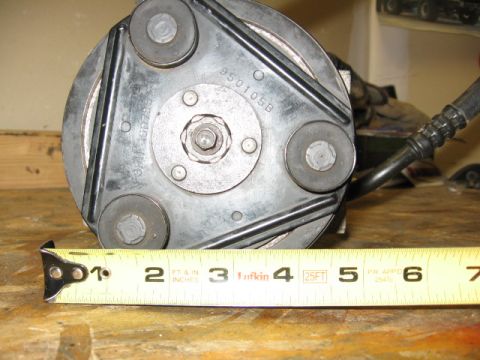 1995 Ford Bronco - AC compressor clutch with part number 950105B shown next to a tape measure.