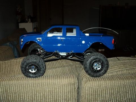 2008 Ford F-250 - RC monster truck with oversized tires is displayed on a couch.