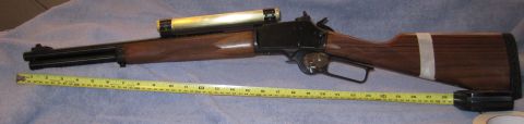 1990 Ford Bronco - A rifle with a scope is laid out next to a yellow tape measure for scale.