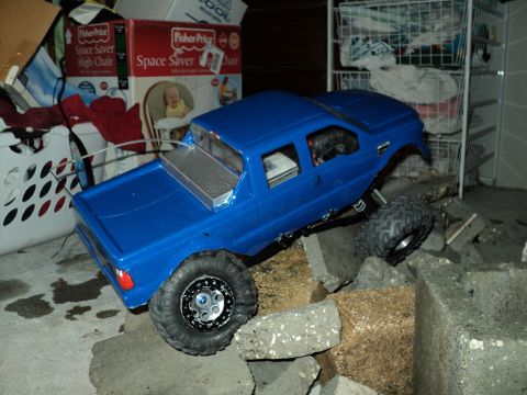 2008 Ford F-250 - RC rock crawler truck is positioned on a pile of concrete blocks.