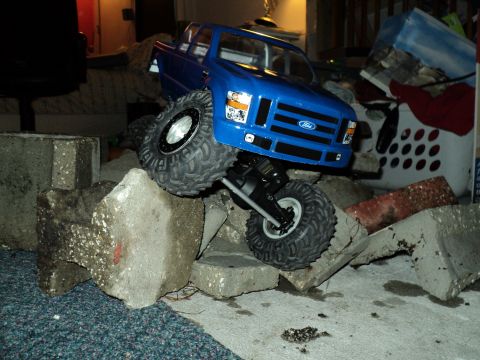 2008 Ford F-250 - This RC model truck, resembling a 2008 Ford F-250, navigates a terrain of concrete debris.