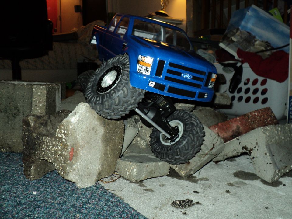 Blue RC Ford F-250 on concrete blocks
