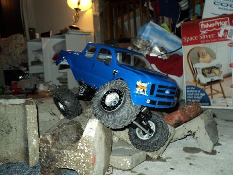 2008 Ford F-250 - RC truck resembling a 2008 Ford F-250 is positioned on a pile of concrete debris.