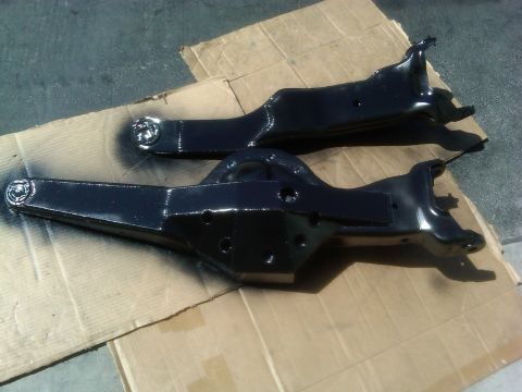 1986 Ford Bronco - Painted suspension parts are laid out on cardboard, ready for installation.