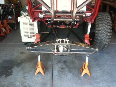 Suzuki Samurai - Custom rear axle assembly, likely for an off-road vehicle, is supported by jack stands in a garage.