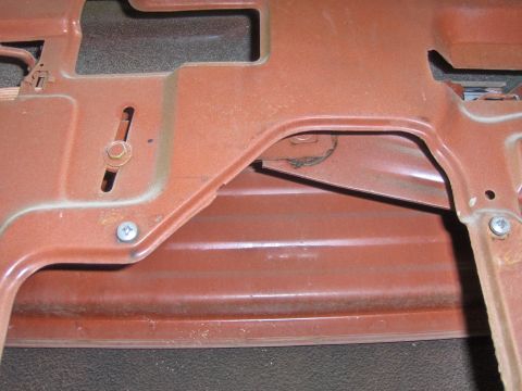 1970 Chevrolet Camaro - Detail of a metal component, possibly from a vehicle's interior or undercarriage, showing fasteners and structural elements.