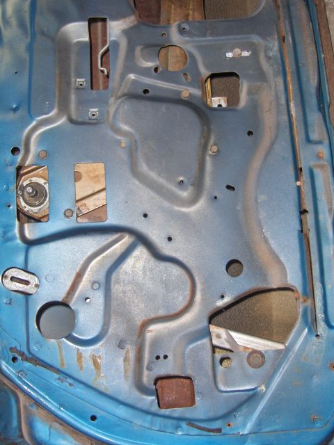 1970 Chevrolet Camaro - The interior structure of a car door is visible, with various holes and bracing elements.