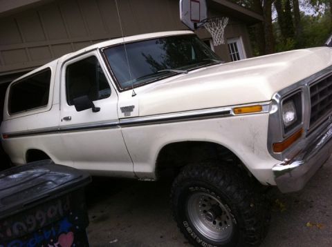 1978 Ford Bronco - This 1978 Ford Bronco is parked in a garage, with a basketball hoop mounted above.