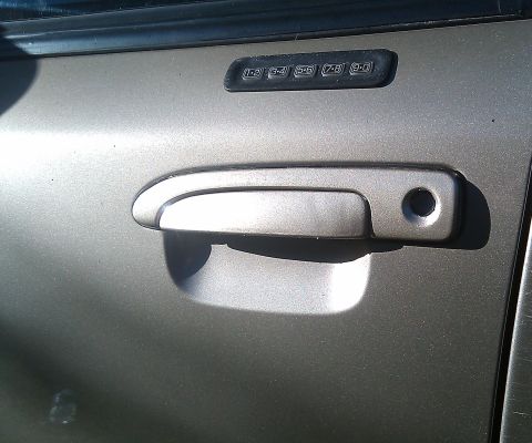 2000 Mercury Grand Marquis - Close-up of a car's door handle and a keypad entry system.