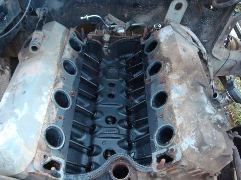 1989 Ford Bronco - Looking straight down into the valley of a big-block Ford V8 with the intake manifold pulled off, exposing the black-painted lifter valley…