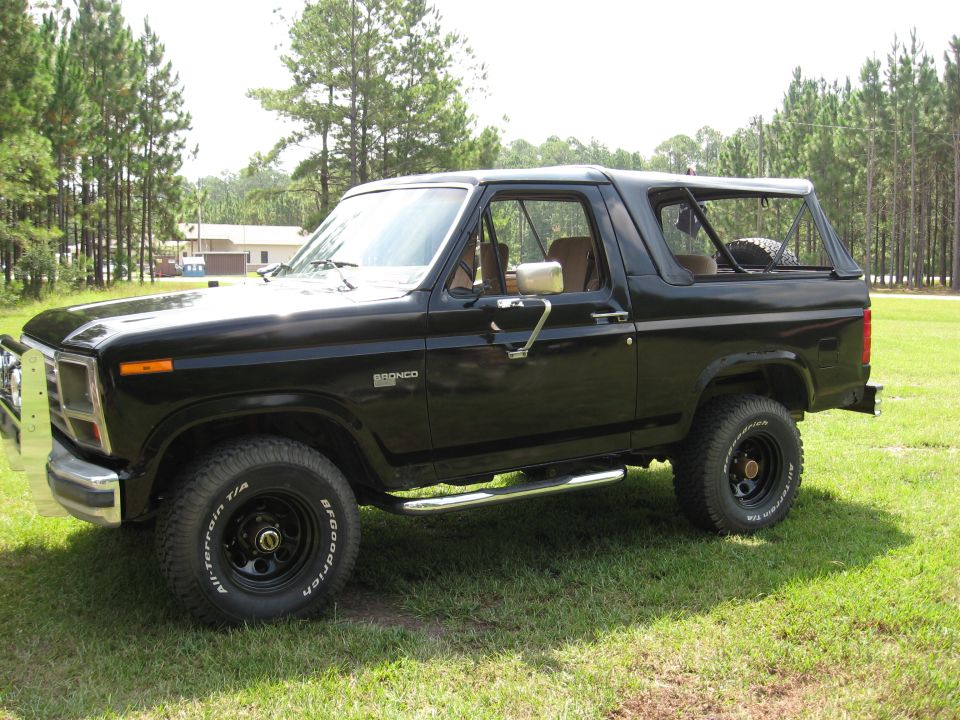 Black Ford Bronco, driver side, top removed, BFG All-Terrain tires on black wheels