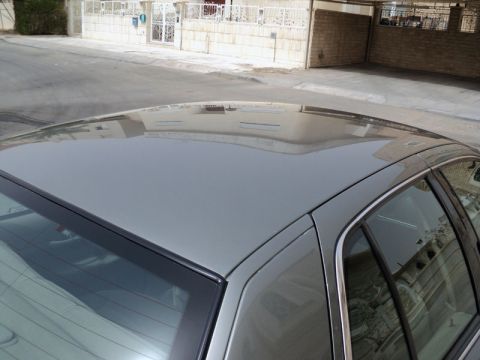 2001 Mercury Grand Marquis - The top of a gray sedan is visible, reflecting the surroundings.
