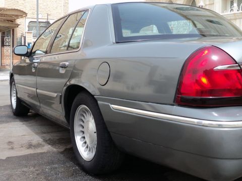 2001 Mercury Grand Marquis - The rear three-quarter view of a gray 2001 Mercury Grand Marquis sedan shows its distinctive taillight and body lines.