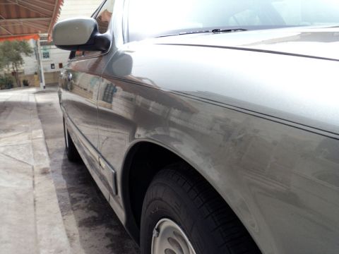 2001 Mercury Grand Marquis - Side view of a silver 2001 Mercury Grand Marquis, showing its distinctive body lines and trim.
