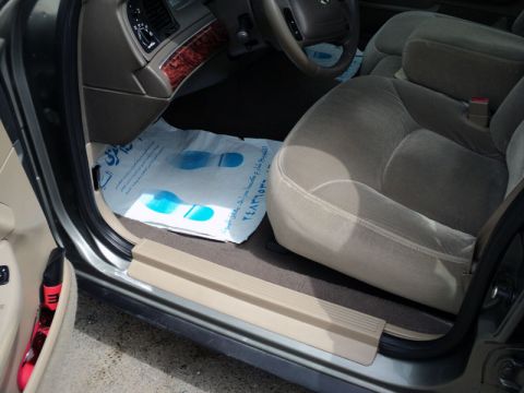 2001 Mercury Grand Marquis - Interior view of a 2001 Mercury Grand Marquis, highlighting the passenger seat and floor mat.