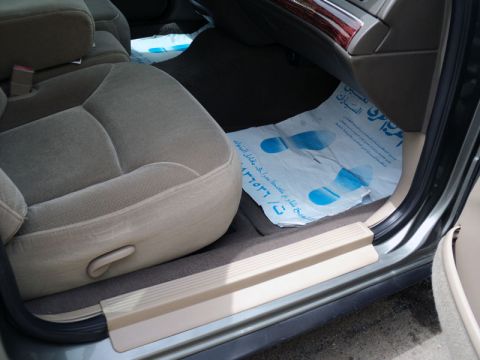 2001 Mercury Grand Marquis - Interior view of a car with beige seats and a protective mat on the floor.