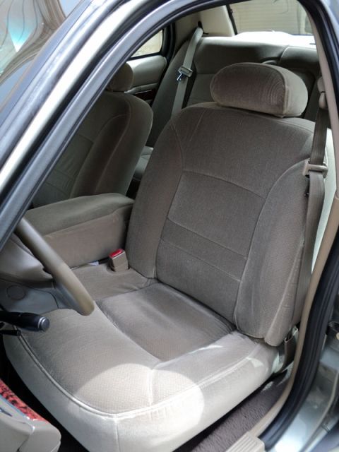 2001 Mercury Grand Marquis - The interior of a 2001 Mercury Grand Marquis features tan cloth seats and a center console.