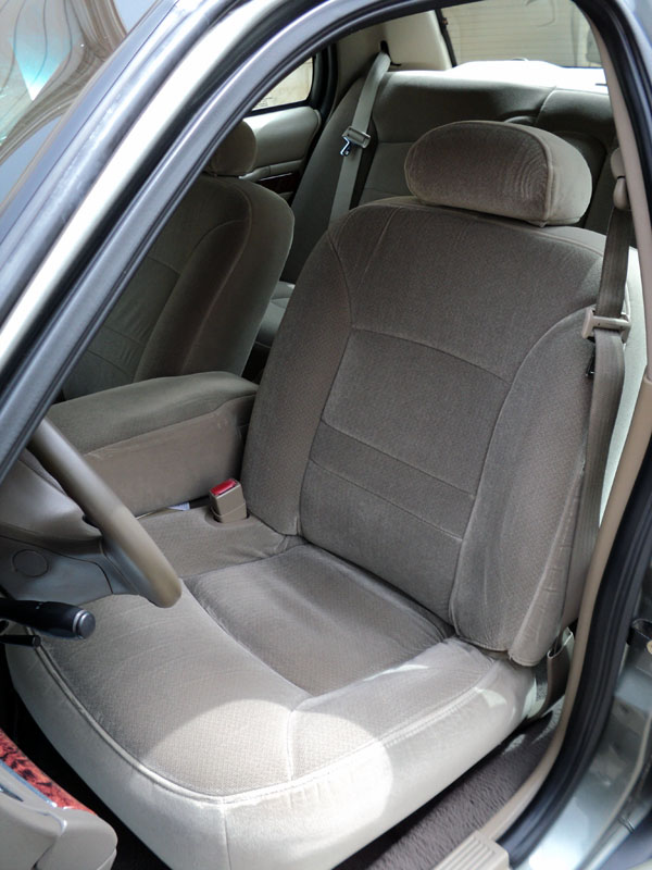 Tan interior of a 2001 Mercury Grand Marquis showing front seats and dashboard