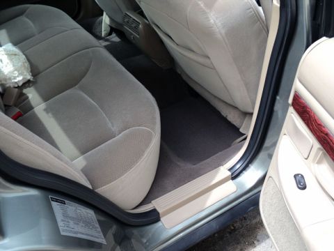 2001 Mercury Grand Marquis - Interior view of the rear passenger area, showing the seats, floor mats, and door trim.