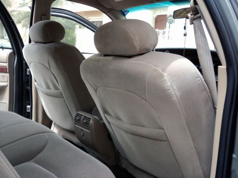 2001 Mercury Grand Marquis - The interior of a 2001 Mercury Grand Marquis features tan cloth seats and a visible SuperMotors.net watermark.