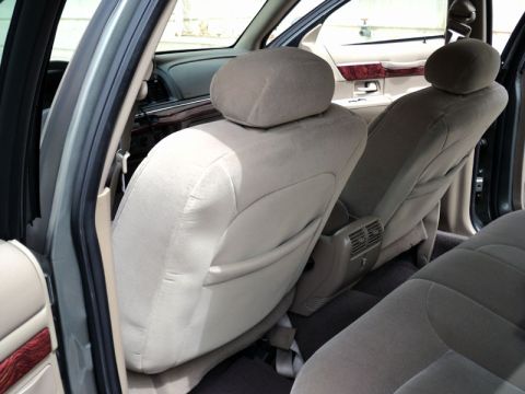2001 Mercury Grand Marquis - Rear interior view of a 2001 Mercury Grand Marquis, showing the seats and wood trim.