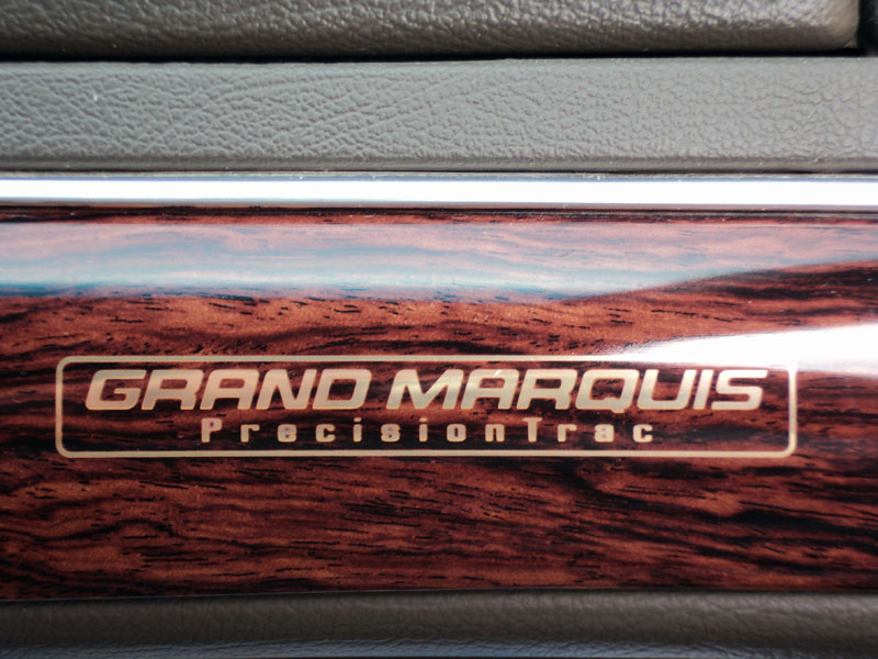 Wood-grain interior trim with "GRAND MARQUIS PrecisionTrac" text