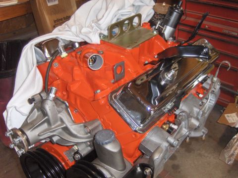 1970 Chevrolet Camaro - Close-up view of a rebuilt V8 engine, orange block paint and polished chrome valve covers.