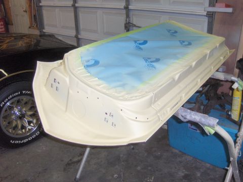 1970 Chevrolet Camaro - Car door undergoing preparation for painting, masked with blue plastic sheeting.