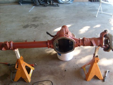 1994 Ford Bronco - Differential axle assembly, likely for a Ford Bronco, is supported by jack stands in a workshop setting.