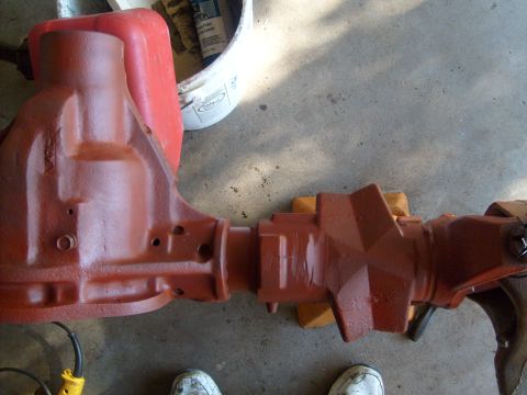 1994 Ford Bronco - Differential housing painted red, resting on wooden blocks.